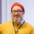 a man in yellow sweater and orange hat