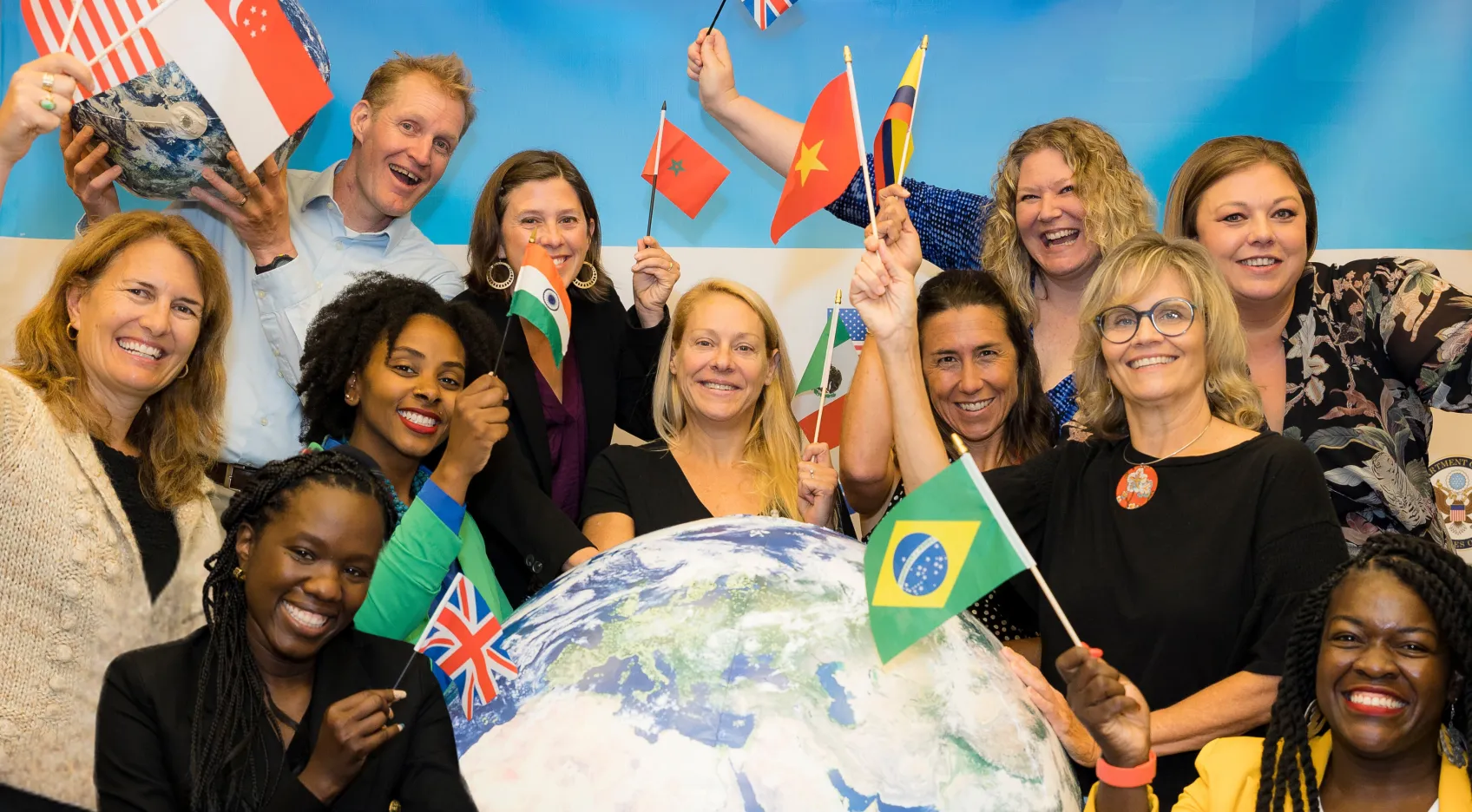 Fulbright Teachers holding flags from around the world