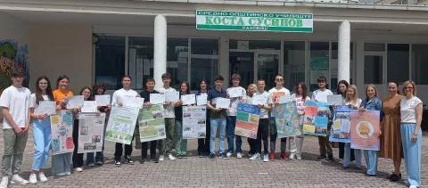 students holding posters outside a school