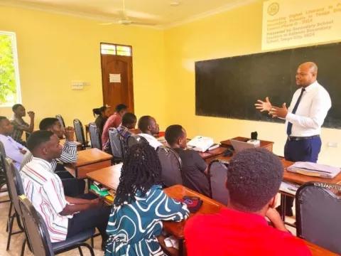 a man in front of a classroom of teachers