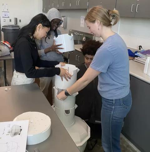 students put together a tower garden