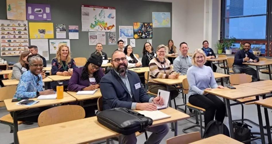 a group of educators at classroom desks