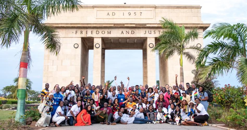 group of teachers standing outside of Black Star Square in Ghana